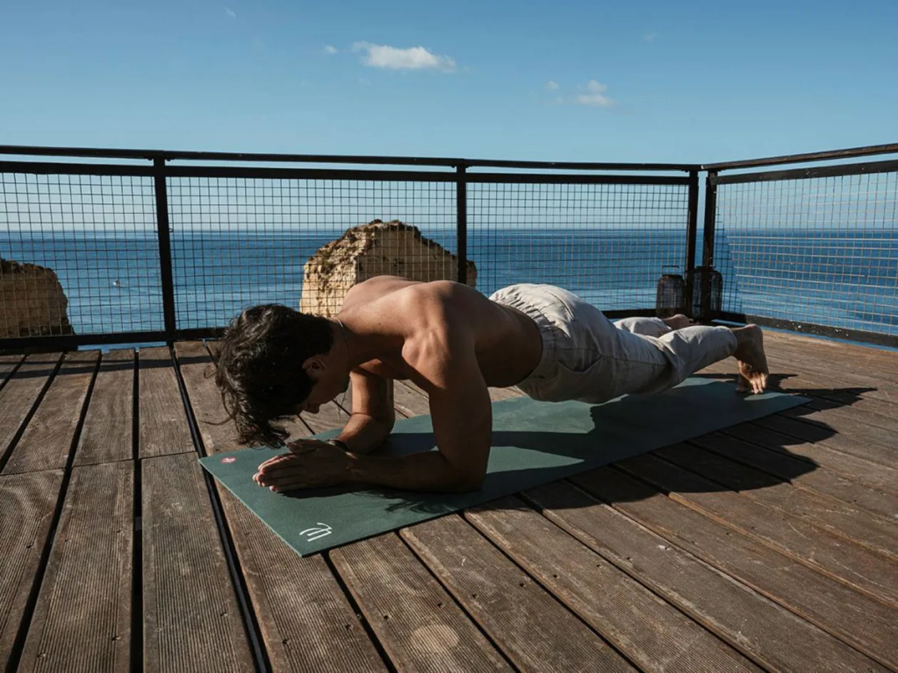 Man practicing yoga at Vilalara Thalassa Resort